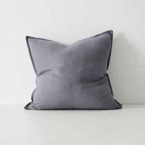 Stack of Como cushions styled on sofa in neutral tones – BLACK Concept Store