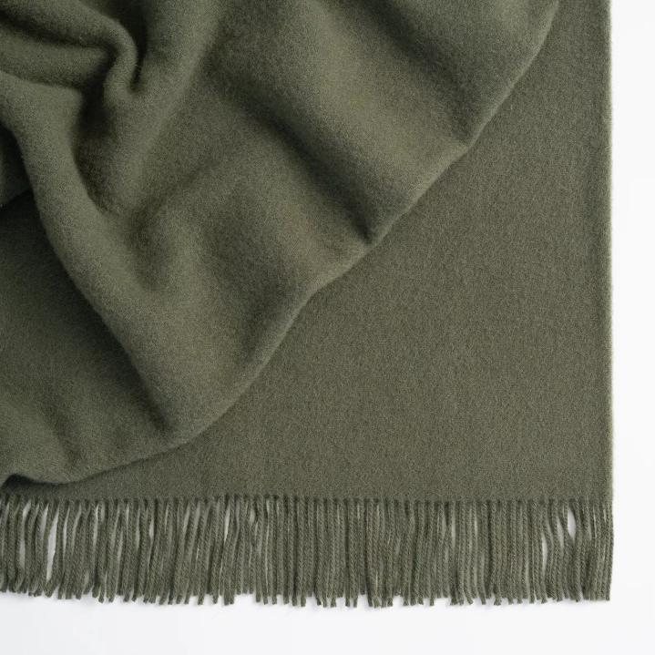 Shop the Nevis lambswool throw 130x200cm – made from 100% New Zealand wool with a soft, thick texture and tassel fringe, perfect for cosy living and gifting.