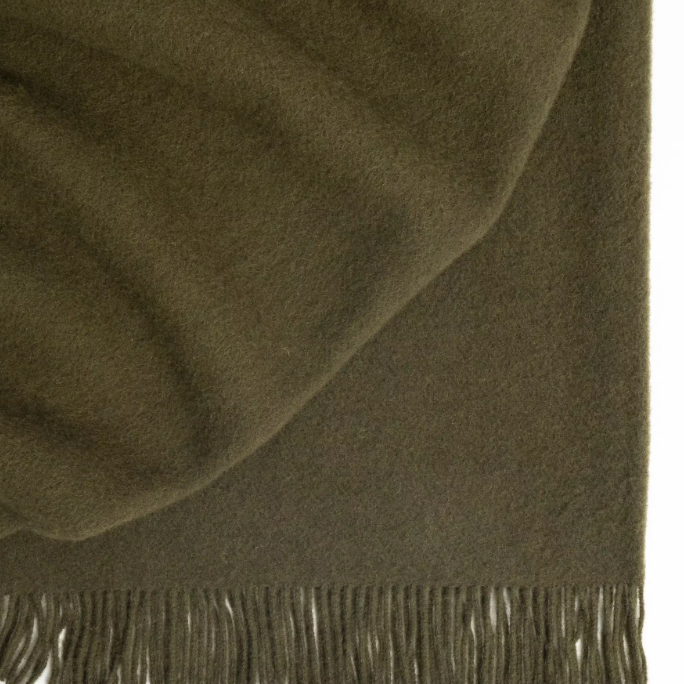 Shop the Nevis lambswool throw 130x200cm – made from 100% New Zealand wool with a soft, thick texture and tassel fringe, perfect for cosy living and gifting.
