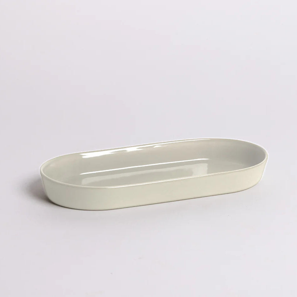 Smooth seamless Noosa Dish styled on a vanity or countertop