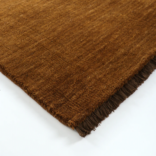 Handknotted pecan brown wool rug styled in modern living room – BLACK Concept Store