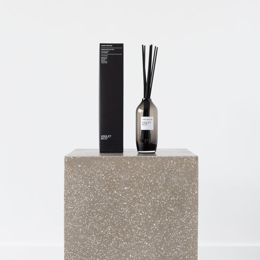 Close-up of Delicate Lily Home Perfume bottle and reed sticks