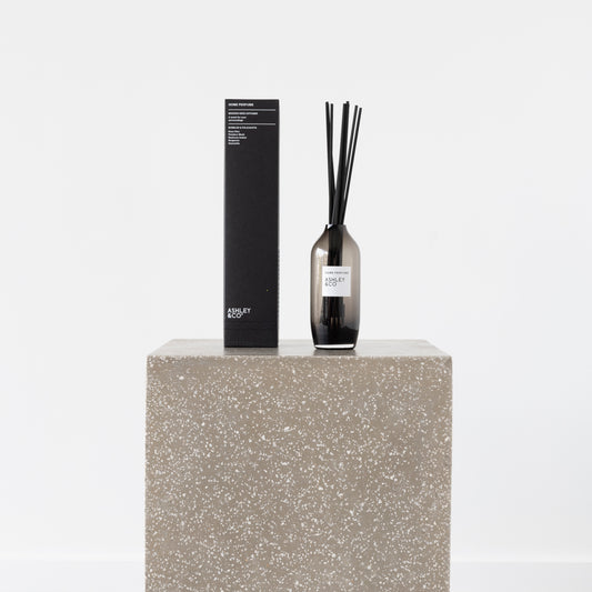 Close-up of Rose Otto Home Perfume bottle and included reeds