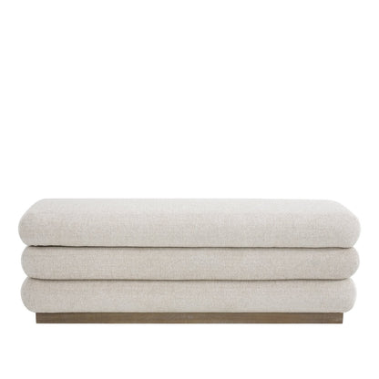 A sculptural upholstered bench with concealed storage, designed for soft comfort and everyday functionality.