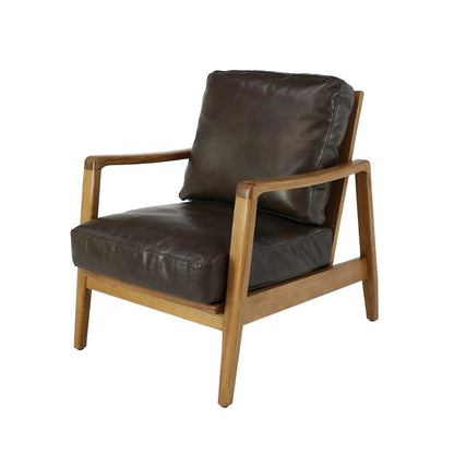 The Reid Armchair blends contemporary design with premium comfort, featuring hand-dyed leather, a sculptural strap backrest with brass buckle detail, and a supportive foam and feather cushion combination.