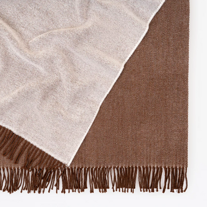 Shop the Harris Merino lambswool throw 145x200cm – reversible, lightweight, and soft with refined texture, perfect for year-round comfort and gifting.