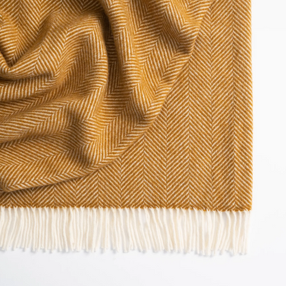 Shop the Magnus wool throw 150x183cm – a thick, 100% New Zealand wool throw with classic herringbone weave and fringe, perfect for cosy living and gifting.