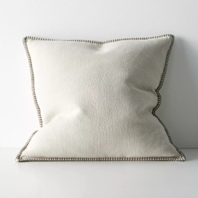 The Alba 50x50cm cushion features a soft linen-poly blend with a subtle two-tone weave and blanket stitch edging, offering relaxed texture and timeless versatility.