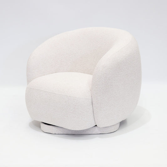 A soft, contemporary occasional chair in a warm cream tone, designed to bring comfort and understated elegance to any space.