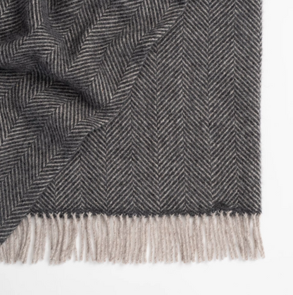 Shop the Lerwick wool throw 150x183cm – a thick, 100% New Zealand wool throw with two-tone herringbone design and fringe, ideal for cosy living and gifting.