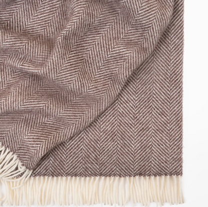Shop the Magnus wool throw 150x183cm – a thick, 100% New Zealand wool throw with classic herringbone weave and fringe, perfect for cosy living and gifting.