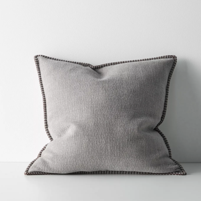 The Alba 50x50cm cushion features a soft linen-poly blend with a subtle two-tone weave and blanket stitch edging, offering relaxed texture and timeless versatility.