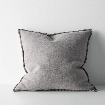 The Alba 50x50cm cushion features a soft linen-poly blend with a subtle two-tone weave and blanket stitch edging, offering relaxed texture and timeless versatility.