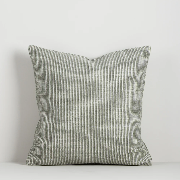 Shop the Baya Dune Outdoor Cushion at Comber and Comber. Handwoven from recycled PET with a textured two-tone design, perfect for stylish outdoor living.