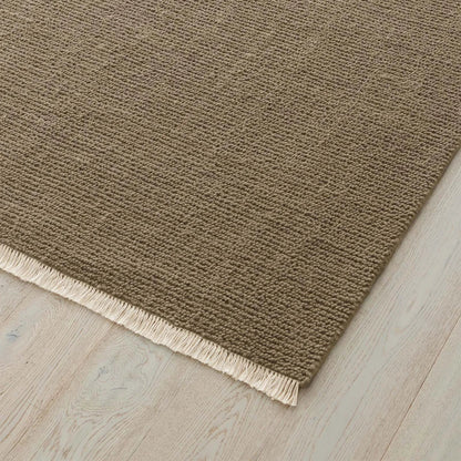 Sandy Beige rug with a textured pattern and fringe on a wooden floor. 2x3 3x4. 100% NZ wool
