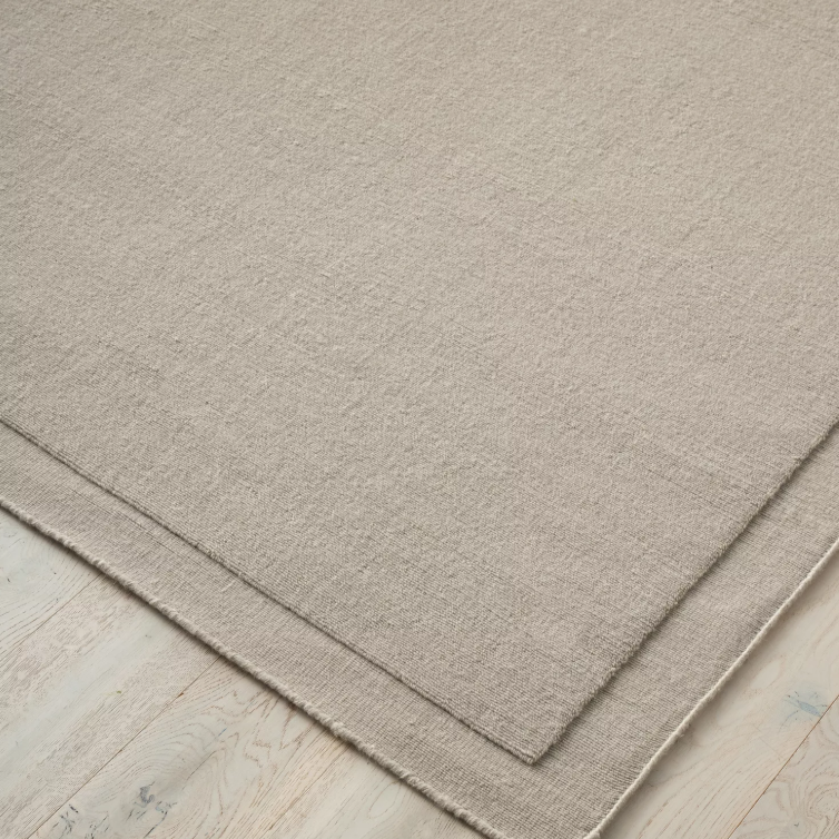 Shop the Cassio Rug — 100% New Zealand wool loop pile with textured finish, serged edge, and durable cotton backing. Available in 4 colours and 2 sizes, perfect for modern living.