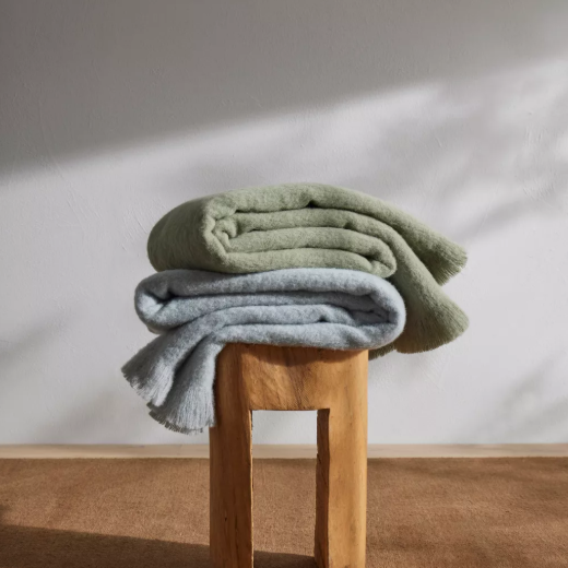 Shop the Hyde wool blend throw 130x200cm – New Zealand made with plush brushed texture and tassel fringe, soft, tactile, and perfect for gifting.