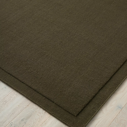 Shop the Cassio Rug — 100% New Zealand wool loop pile with textured finish, serged edge, and durable cotton backing. Available in 4 colours and 2 sizes, perfect for modern living.