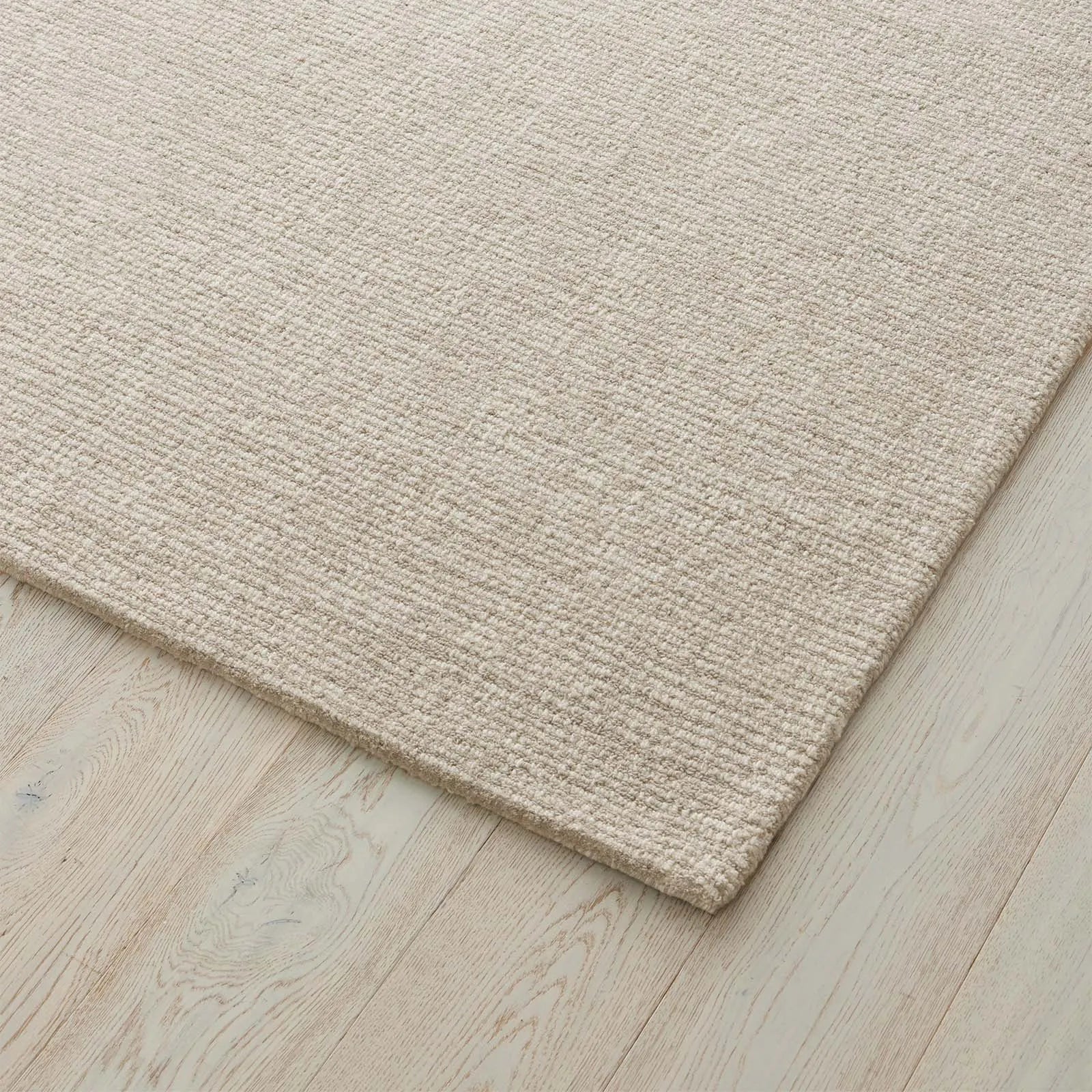 Beige rug on a wooden floor. 2x3. 100 NZ Wool