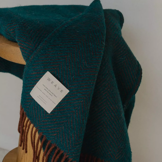 Shop the Lerwick wool throw 150x183cm – a thick, 100% New Zealand wool throw with two-tone herringbone design and fringe, ideal for cosy living and gifting.