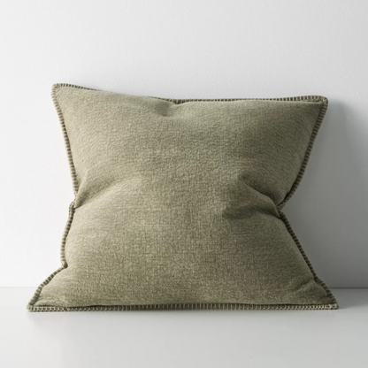 The Alba 50x50cm cushion features a soft linen-poly blend with a subtle two-tone weave and blanket stitch edging, offering relaxed texture and timeless versatility.