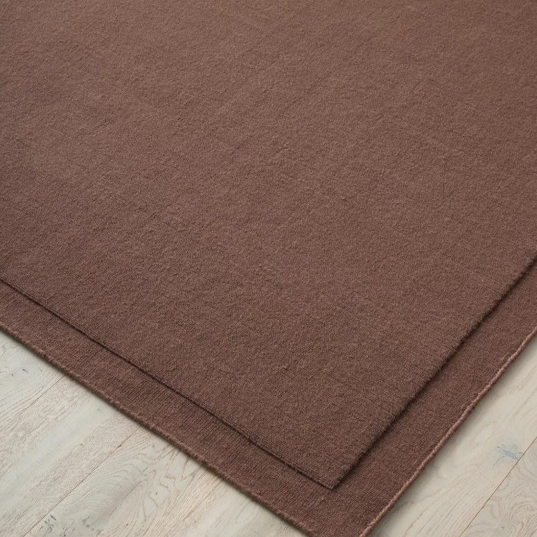 Shop the Cassio Rug — 100% New Zealand wool loop pile with textured finish, serged edge, and durable cotton backing. Available in 4 colours and 2 sizes, perfect for modern living.