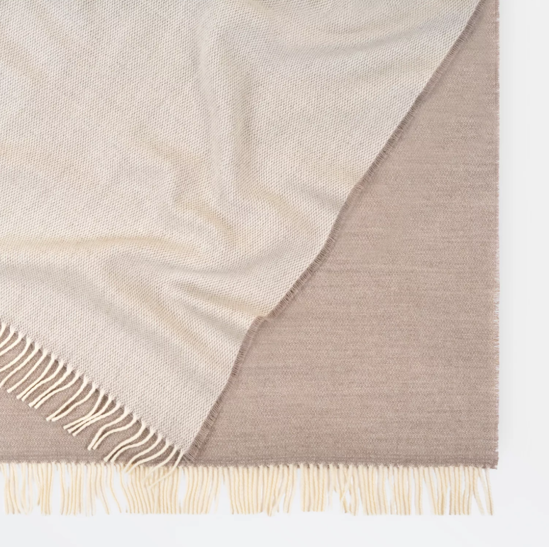 Shop the Harris Merino lambswool throw 145x200cm – reversible, lightweight, and soft with refined texture, perfect for year-round comfort and gifting.