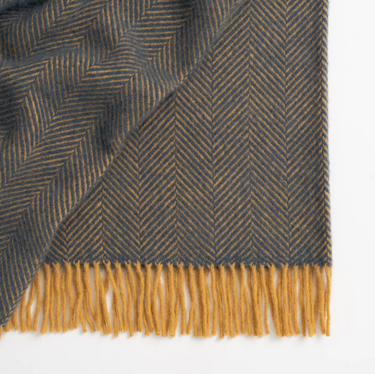 Shop the Lerwick wool throw 150x183cm – a thick, 100% New Zealand wool throw with two-tone herringbone design and fringe, ideal for cosy living and gifting.