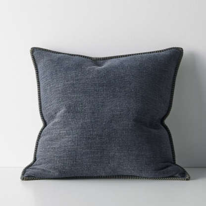 The Alba 50x50cm cushion features a soft linen-poly blend with a subtle two-tone weave and blanket stitch edging, offering relaxed texture and timeless versatility.