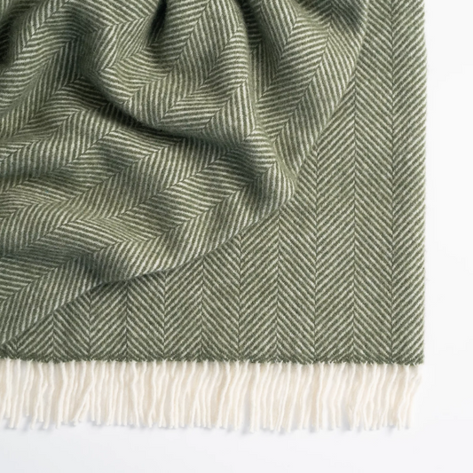 Shop the Magnus wool throw 150x183cm – a thick, 100% New Zealand wool throw with classic herringbone weave and fringe, perfect for cosy living and gifting.