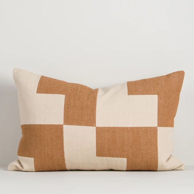 A striking geometric cushion in warm oat and caramel tones, designed to bring texture, pattern, and contemporary style to any interior.