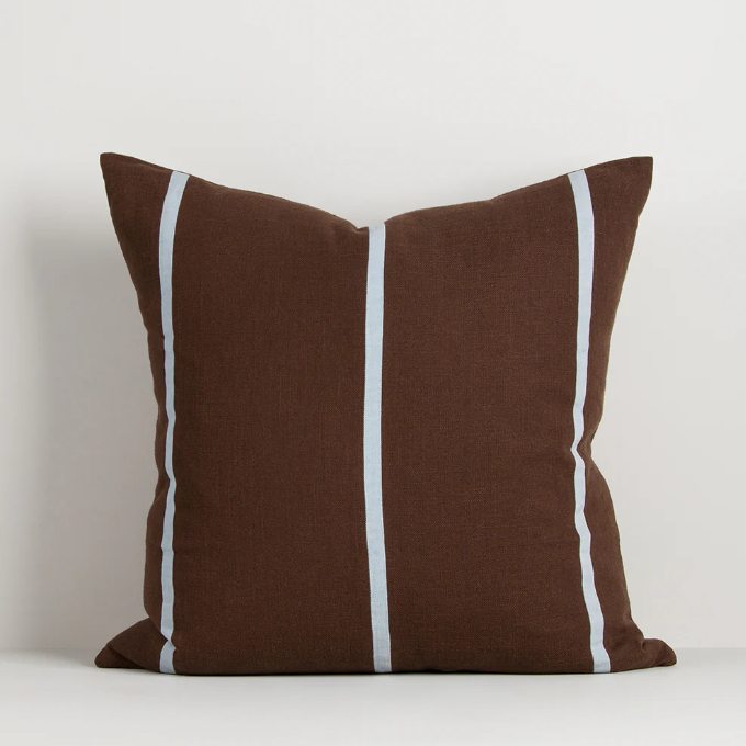 A contemporary cotton cushion featuring bold appliqué stripes in warm caramel tones, designed to add texture and character to modern interiors.