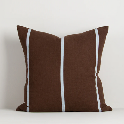 A contemporary cotton cushion featuring bold appliqué stripes in warm caramel tones, designed to add texture and character to modern interiors.