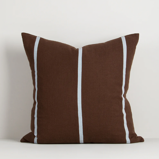 A contemporary cotton cushion featuring bold appliqué stripes in warm caramel tones, designed to add texture and character to modern interiors.