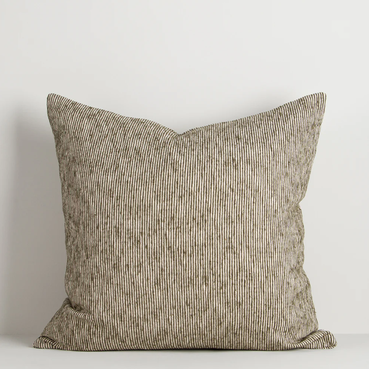 A beautifully textured cotton cushion featuring a subtle pinstripe weave and earthy colour palette, designed to bring warmth, depth, and effortless layering to contemporary interiors.