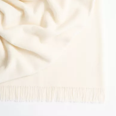 Nevis throw draped on a sofa for cozy winter style