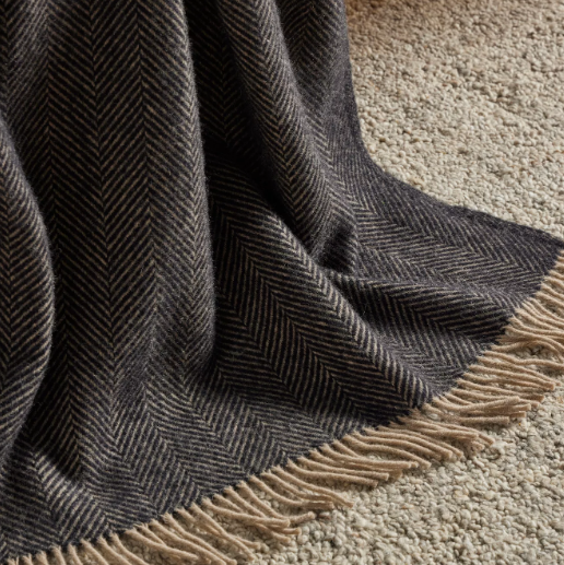 Shop the Lerwick wool throw 150x183cm – a thick, 100% New Zealand wool throw with two-tone herringbone design and fringe, ideal for cosy living and gifting.