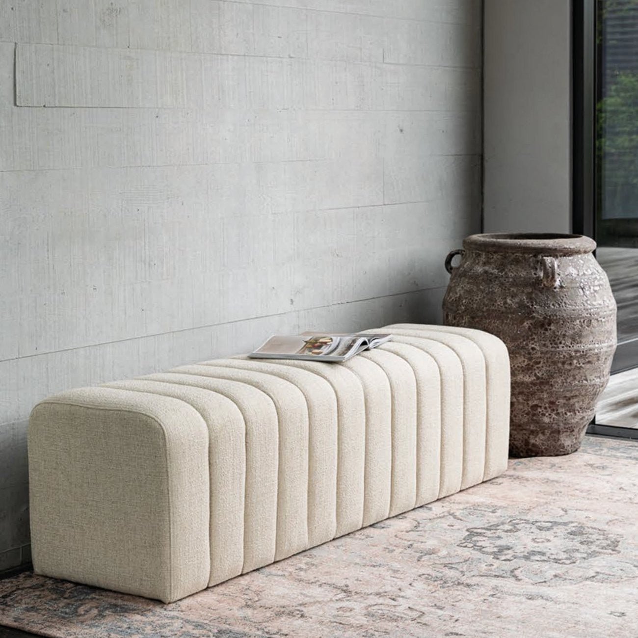 A contemporary upholstered bench in a soft alabaster fabric, designed for comfort, texture, and everyday functionality.