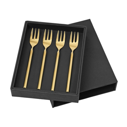 Set of four gold cake forks in a black box 