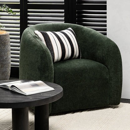 A sculptural swivel chair with deep comfort, tailored curves, and a timeless, versatile design.